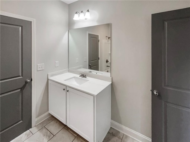 bathroom with vanity and baseboards