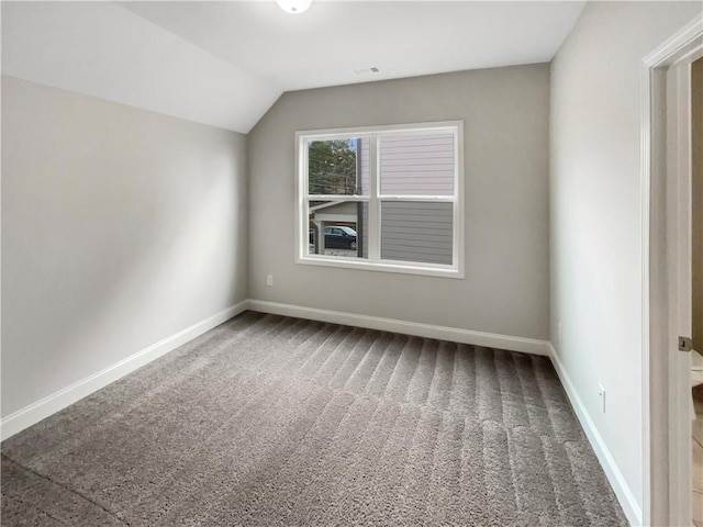 additional living space featuring carpet floors, visible vents, baseboards, and vaulted ceiling