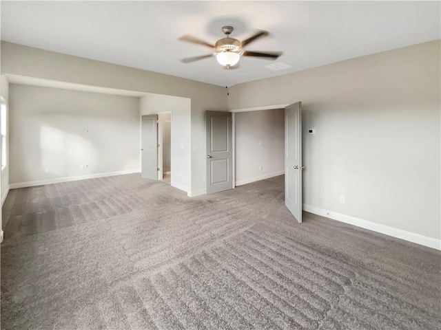 spare room with carpet floors, ceiling fan, and baseboards