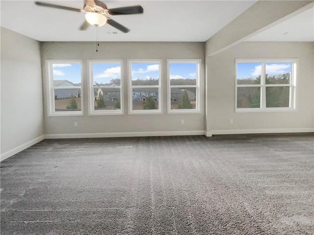 unfurnished room featuring ceiling fan, visible vents, and baseboards
