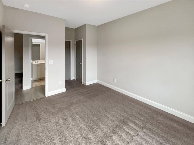 unfurnished bedroom with carpet floors and baseboards