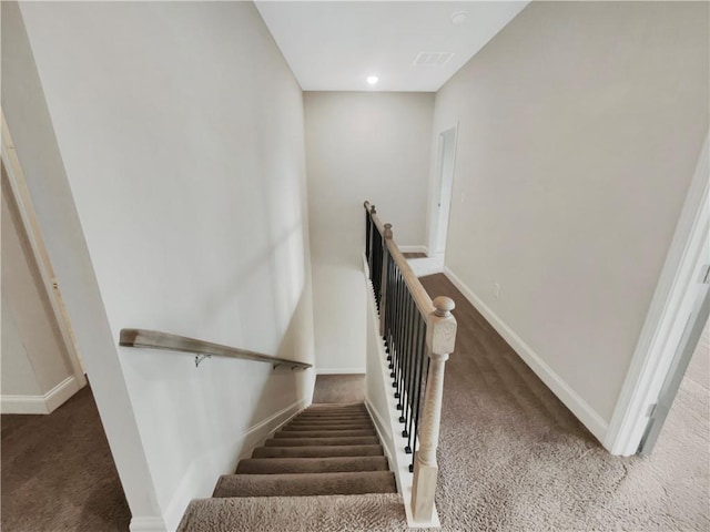stairs featuring carpet and baseboards