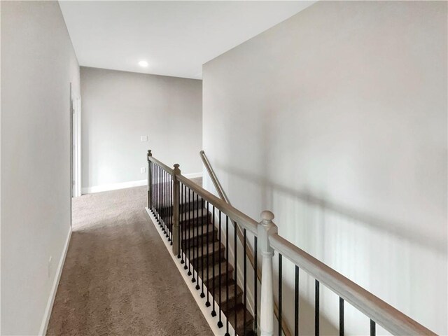 corridor with recessed lighting, baseboards, carpet flooring, and an upstairs landing