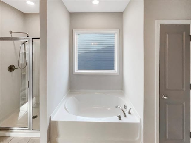 full bath with tile patterned flooring, a shower stall, and a bath