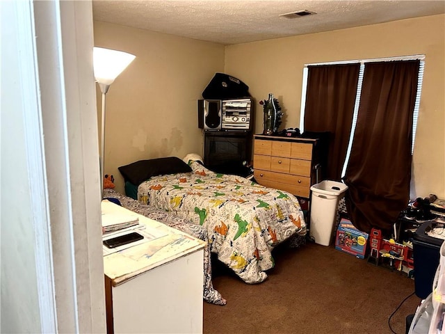 carpeted bedroom featuring a textured ceiling