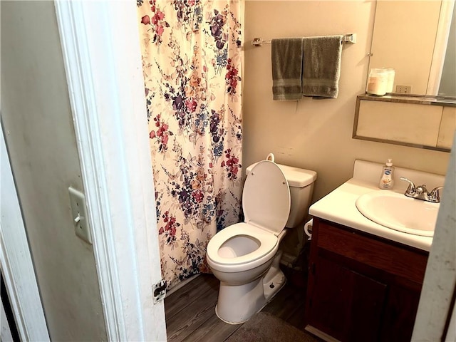 bathroom featuring hardwood / wood-style flooring, vanity, and toilet