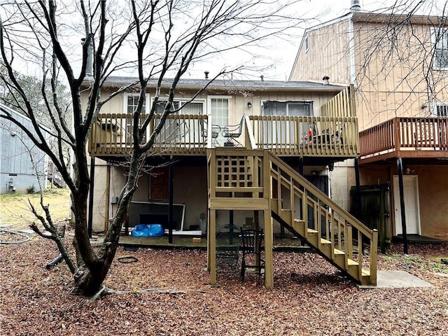 back of property with a wooden deck