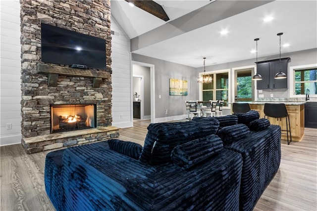 1441 Whitestone Rd, Talking Rock, GA 30175 - living room with light wood-style floors, a stone fireplace, baseboards, vaulted ceiling, and recessed lighting