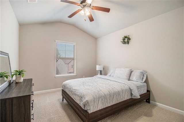 bedroom featuring light carpet, vaulted ceiling, baseboards, and ceiling fan