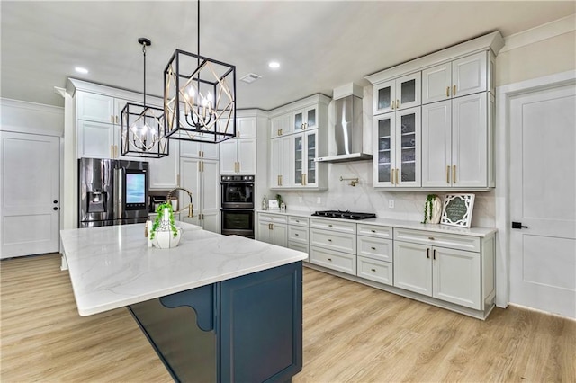 2634 Greenes Ln, Powder Springs, GA 30127 - kitchen featuring a kitchen island with sink, wall chimney range hood, black appliances, glass insert cabinets, and pendant lighting