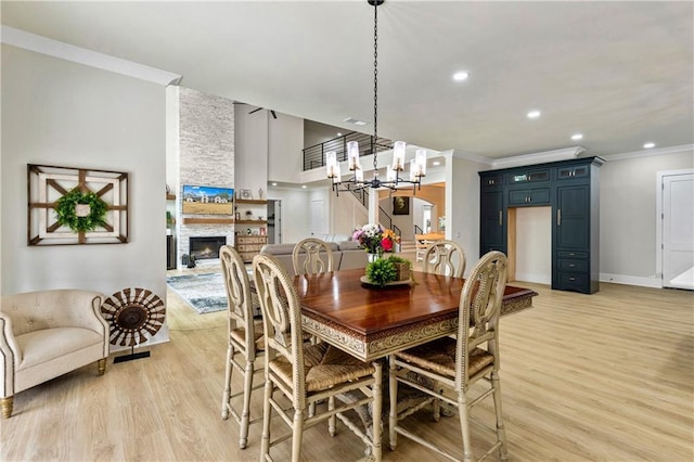 2634 Greenes Ln, Powder Springs, GA 30127 - dining space with a notable chandelier, ornamental molding, and light wood-style floors