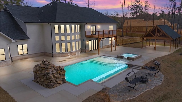 2634 Greenes Ln, Powder Springs, GA 30127 - pool at dusk featuring a pool with connected hot tub, a patio area, and a gazebo