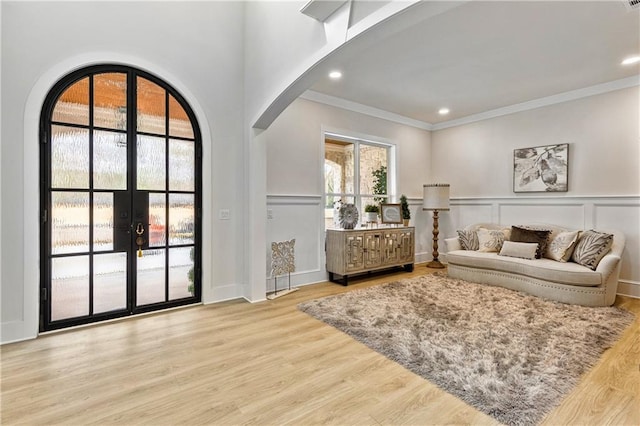 2634 Greenes Ln, Powder Springs, GA 30127 - interior space featuring arched walkways, a decorative wall, ornamental molding, wainscoting, and wood finished floors