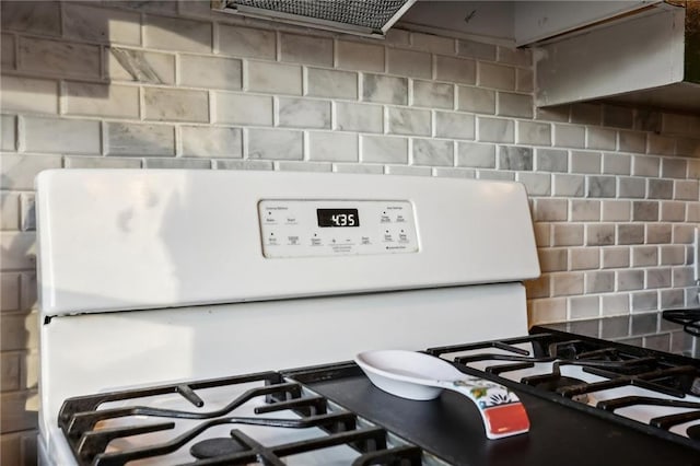 room details with tasteful backsplash and white gas stove