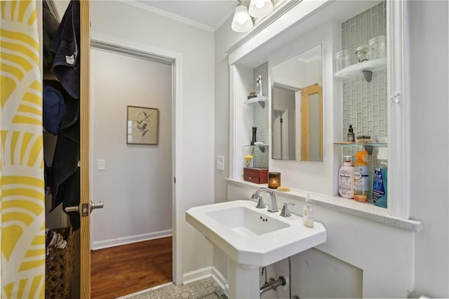 bathroom with sink, wood-type flooring, and ornamental molding