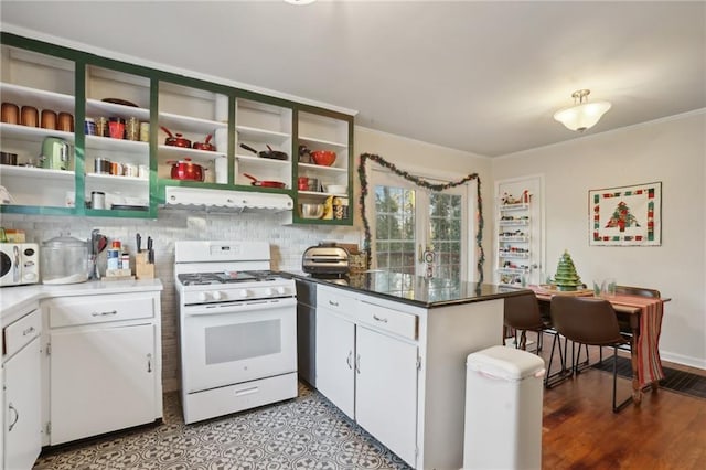 kitchen featuring decorative backsplash, white cabinetry, light hardwood / wood-style floors, and white appliances