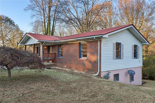 view of home's exterior featuring covered porch and a yard