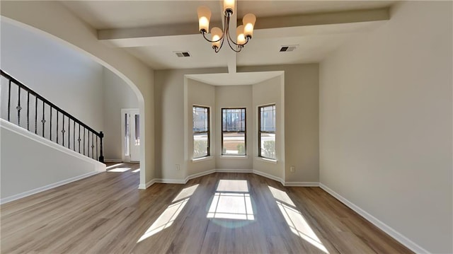 interior space with stairway, baseboards, visible vents, and wood finished floors