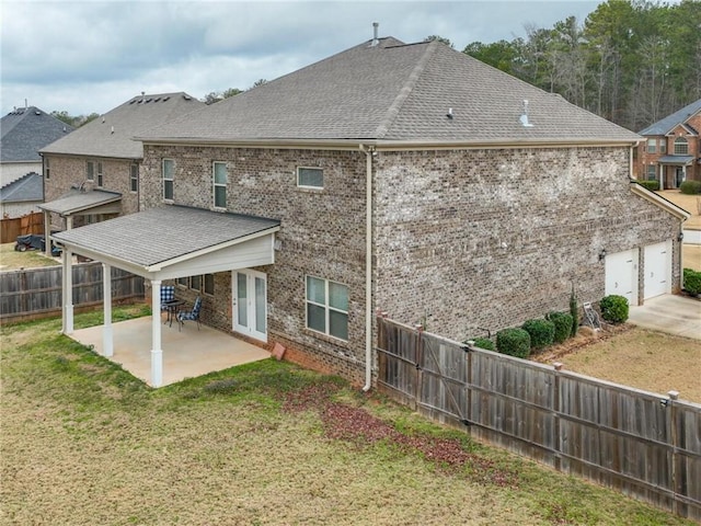 back of house featuring a patio and a lawn