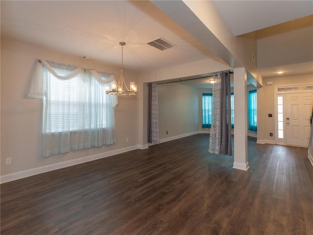 foyer with a notable chandelier and dark hardwood / wood-style floors