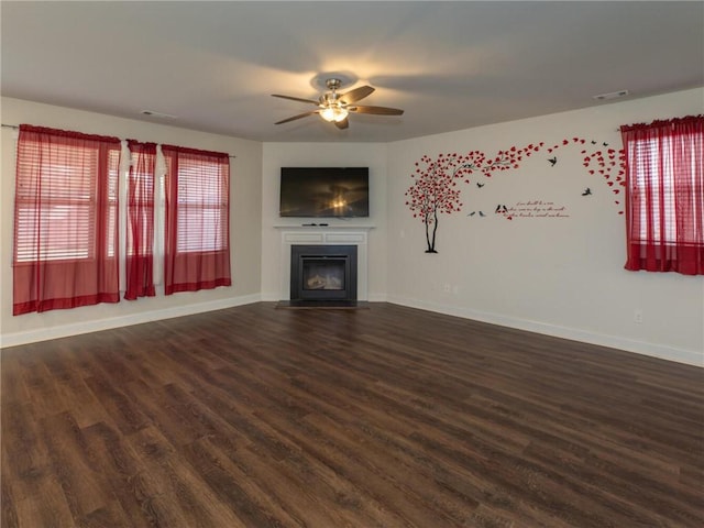 unfurnished living room with dark hardwood / wood-style floors and ceiling fan