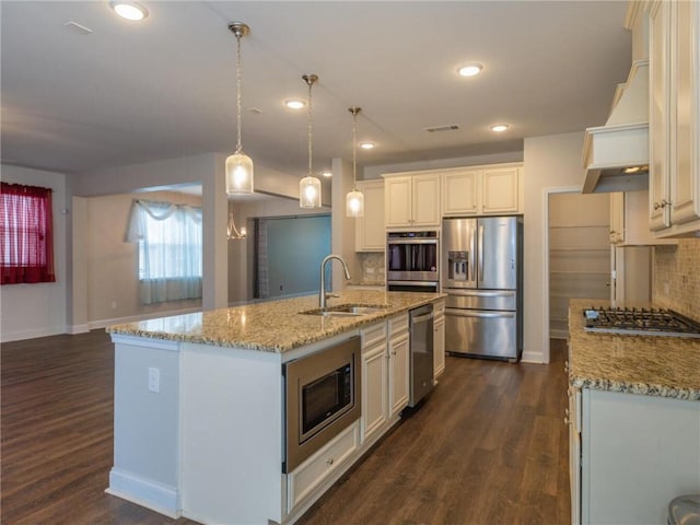 kitchen with a kitchen island with sink, sink, white cabinetry, and stainless steel appliances