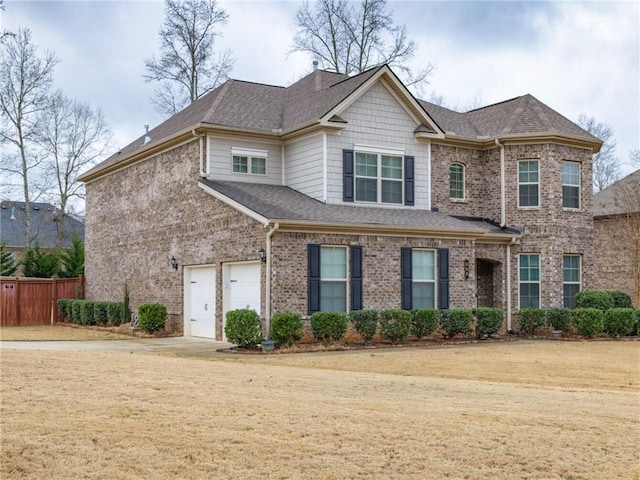 view of front of home featuring a garage and a front yard