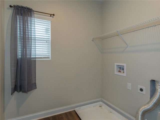 washroom featuring electric dryer hookup, washer hookup, hardwood / wood-style floors, and a healthy amount of sunlight