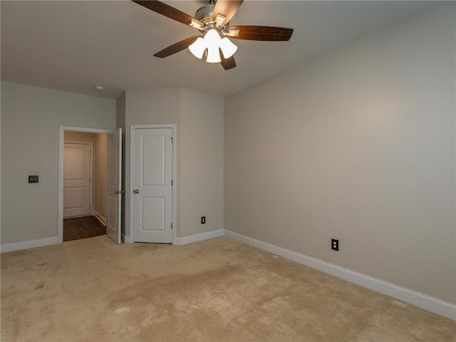 spare room featuring ceiling fan and light colored carpet