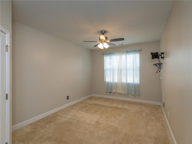 unfurnished room featuring light colored carpet and ceiling fan