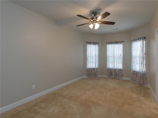 empty room with light colored carpet and ceiling fan