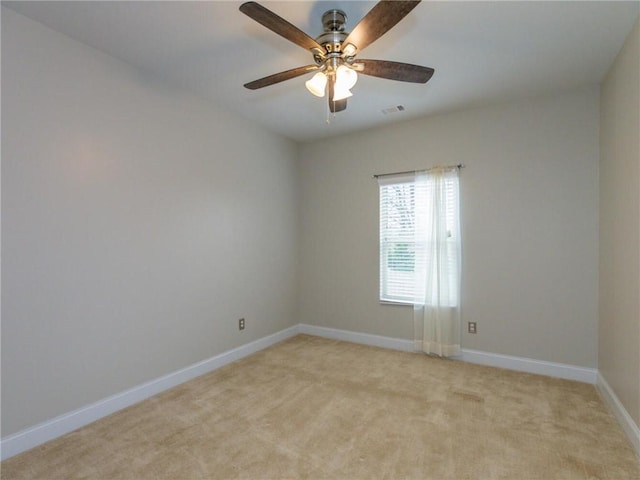 carpeted spare room featuring ceiling fan