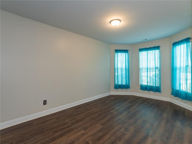 empty room featuring dark hardwood / wood-style flooring