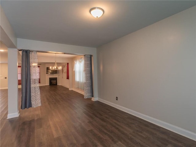 unfurnished living room featuring dark hardwood / wood-style flooring