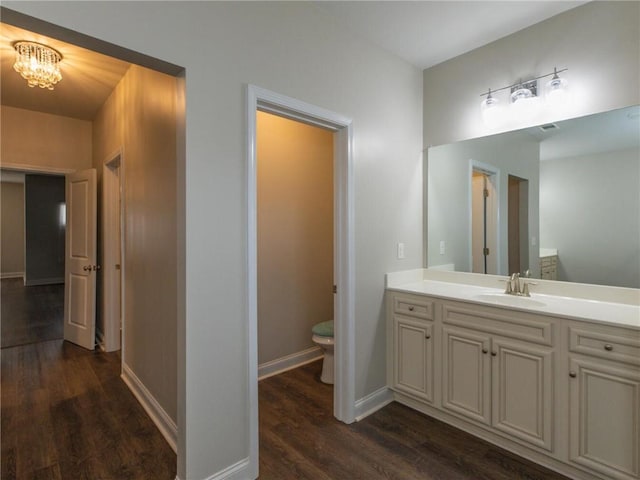 bathroom with vanity, hardwood / wood-style floors, and toilet