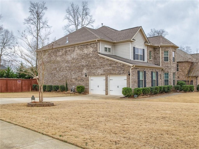 view of front of house featuring a garage and a front lawn