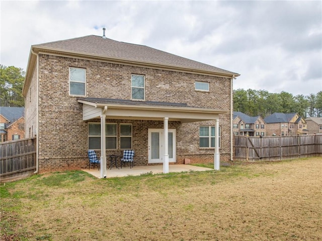 back of house featuring a yard and a patio area