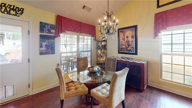 dining area featuring vaulted ceiling, dark hardwood / wood-style floors, and a notable chandelier