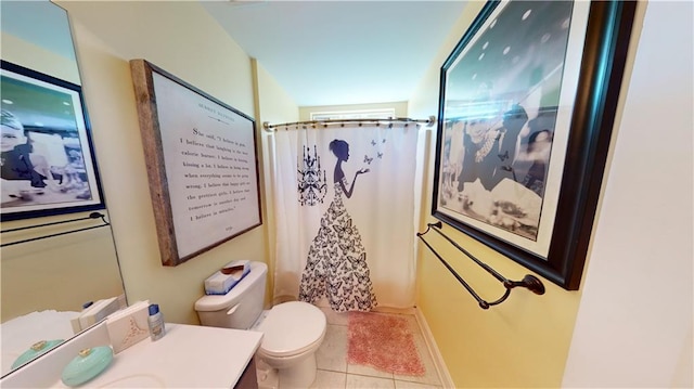 bathroom featuring vanity, tile patterned floors, toilet, and walk in shower