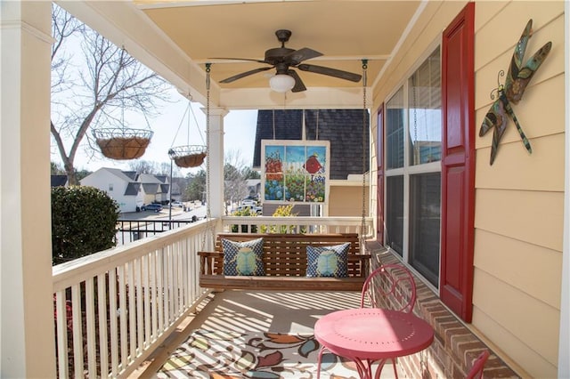 balcony with a porch and ceiling fan