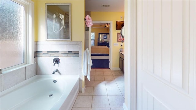 bathroom featuring tile patterned flooring and a bath