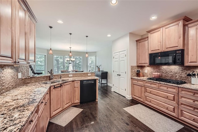 kitchen featuring dark wood-type flooring, decorative backsplash, a peninsula, black appliances, and a sink