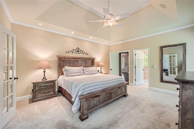 bedroom with a raised ceiling, crown molding, carpet flooring, and french doors