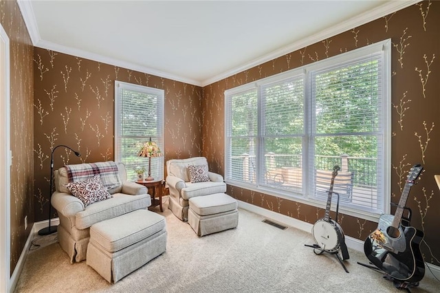 sitting room with baseboards, visible vents, carpet floors, wallpapered walls, and ornamental molding