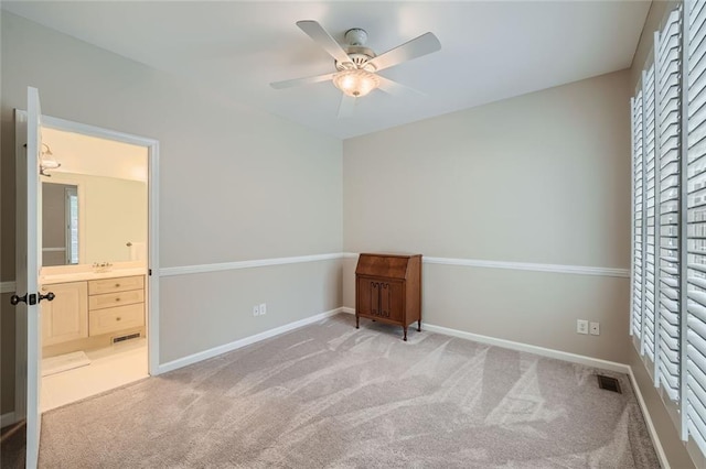 unfurnished bedroom with carpet flooring, visible vents, baseboards, and connected bathroom