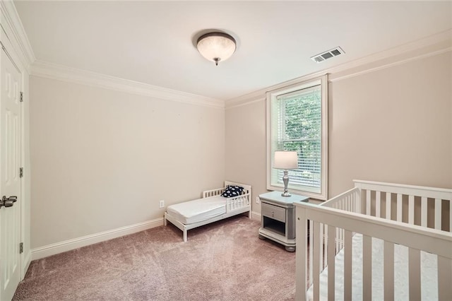 bedroom featuring visible vents, baseboards, crown molding, and carpet