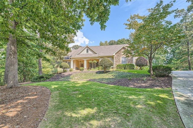 view of front of house featuring stone siding and a front yard