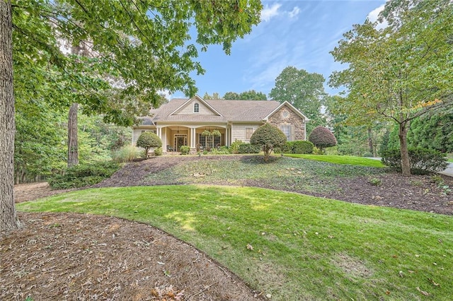 view of front of house with stone siding and a front yard