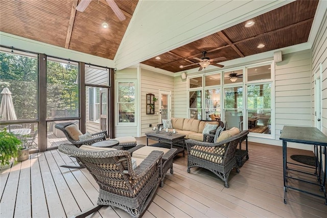 sunroom featuring wooden ceiling, a ceiling fan, and a healthy amount of sunlight