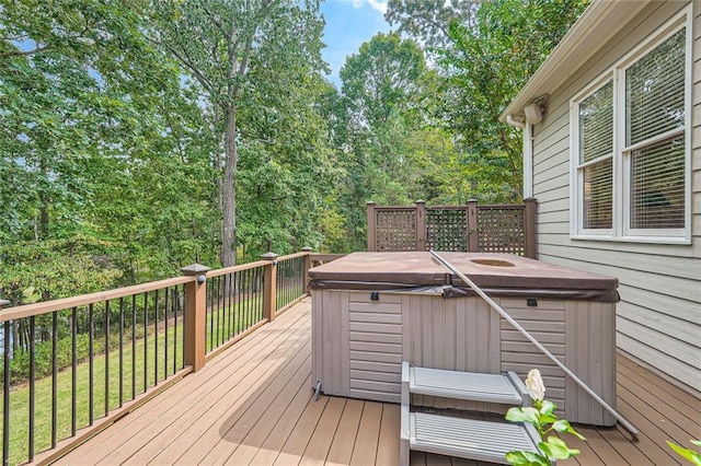 wooden terrace featuring a hot tub